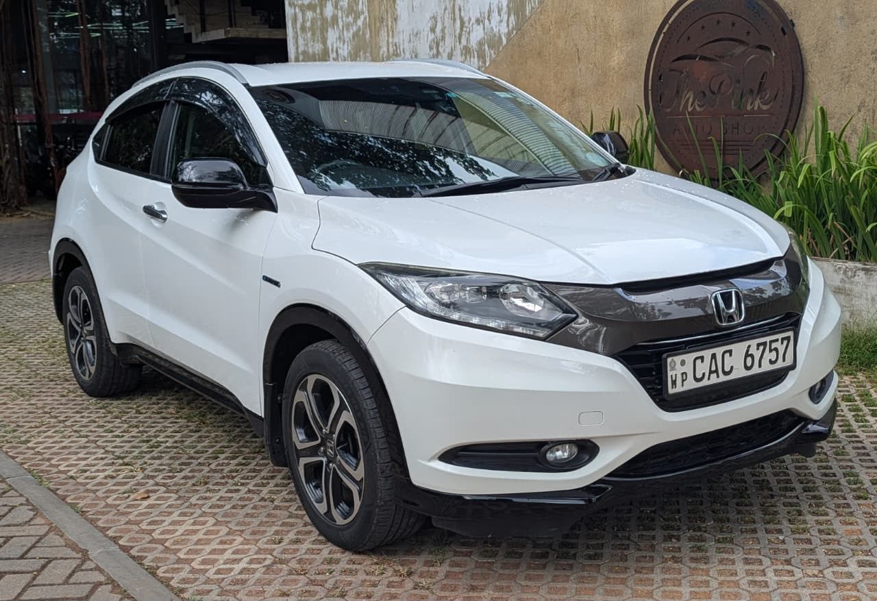 Ceylon Now Compact SUV, a white Honda Vezel, parked outside an auto shop in Sri Lanka